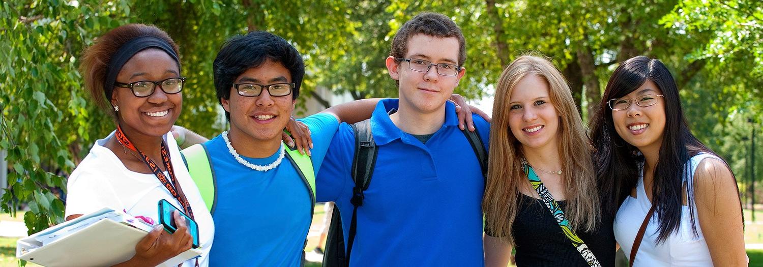 students grouped together for a photo in the campus mall